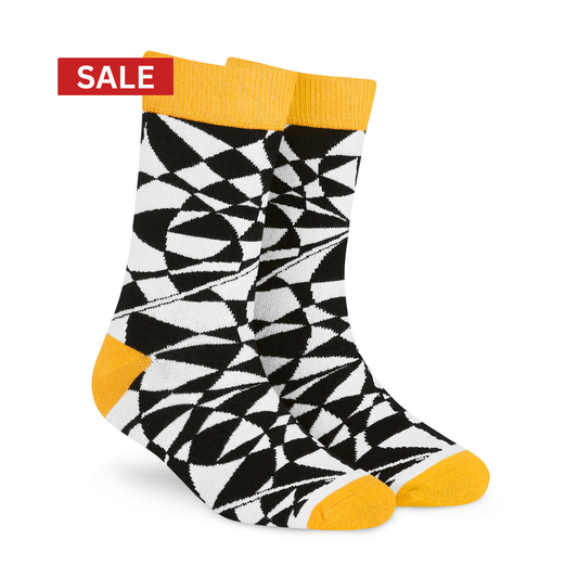 A pair of crew socks with a bold black and white geometric pattern, featuring solid yellow cuffs, heels, and toes. A red 'SALE' banner is overlaid in the top-left corner on a clean white background.
